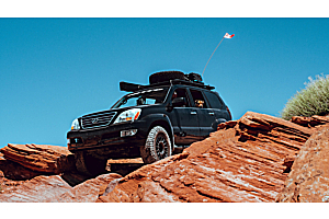 Lifted Toyota 4Runner offroading in the mountains on a sunny day. 