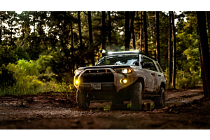 Lifted Toyota 4Runner offroading in the mountains on a sunny day. 