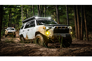 Lifted Toyota 4Runner offroading in the mountains on a sunny day. 