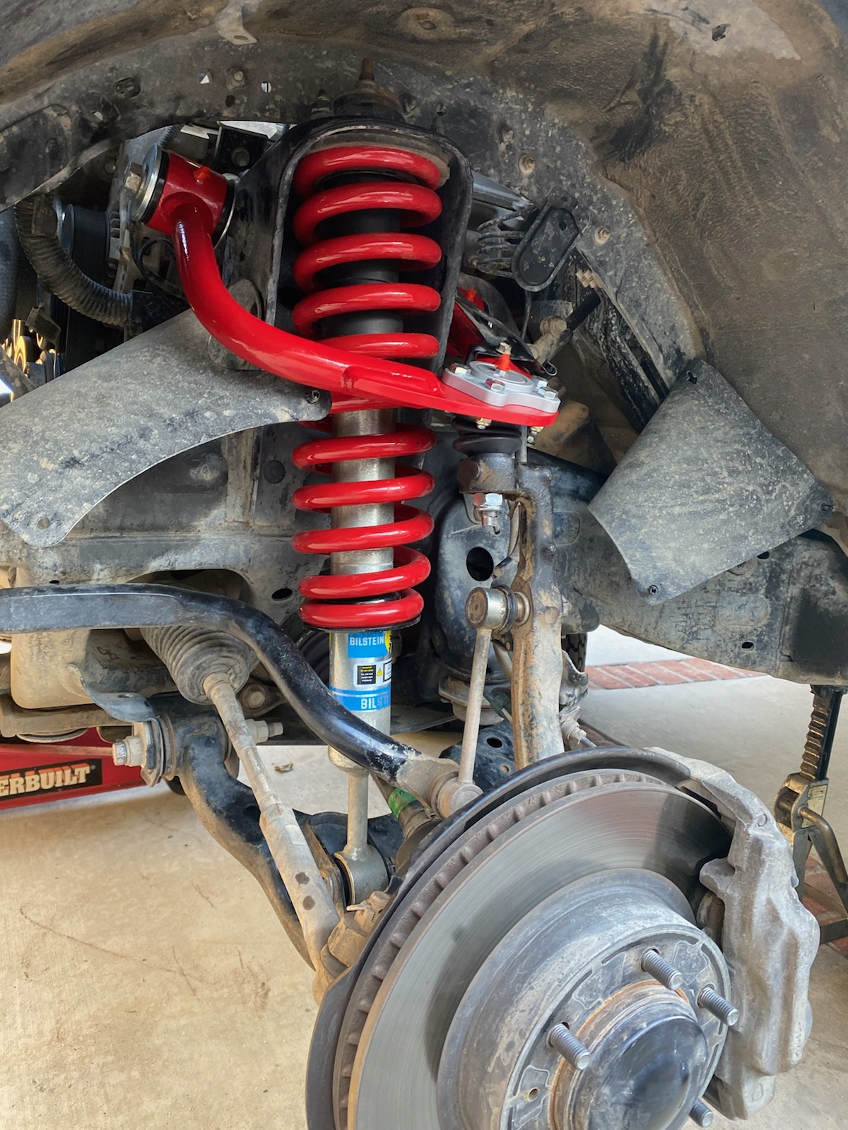 Full view of a red JBA Offroad upper control arm.