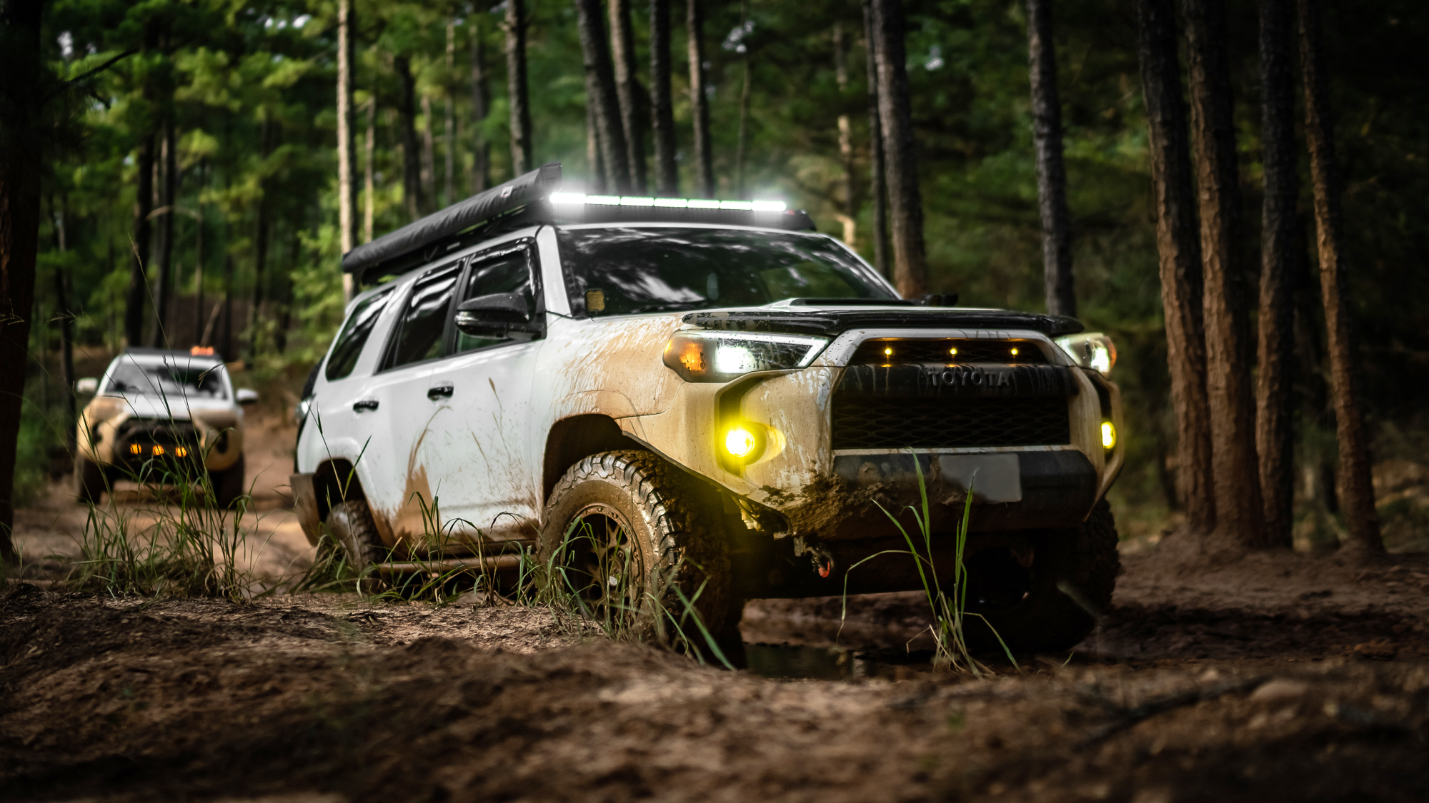 Lifted Toyota 4Runner offroading in the mountains on a sunny day. 