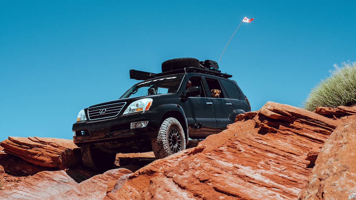 Lifted Lexus offroading in the mountains on a sunny day. 